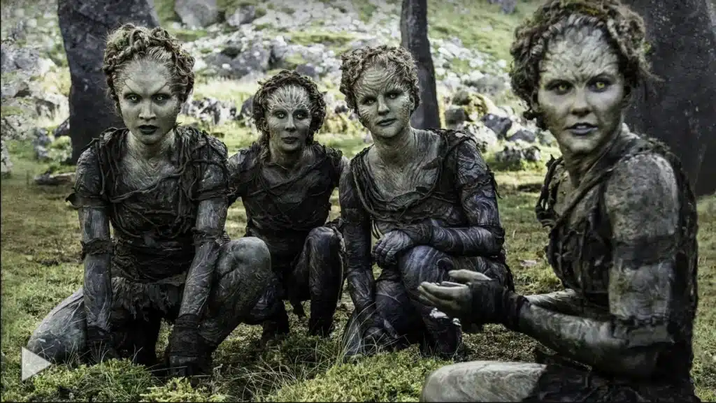 Four children of the forest squatting in grass